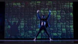 Tyler Knowles dancing on stage in the the Mill Creek Fall Dance Show Iconic.