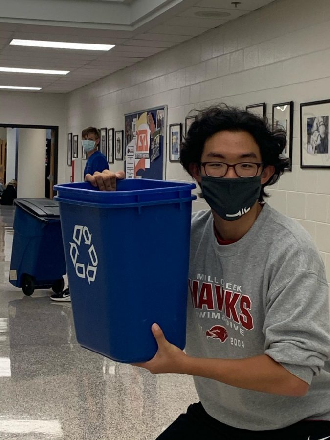 Cory Shin, 12, collecting recycles as part of a Environmental club activity.