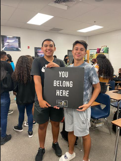 HoPe club members Daniel Candamil and Alex Winberg proudly display their poster.