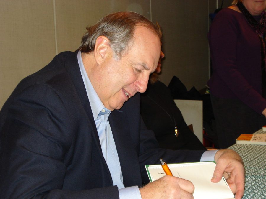 Michael Gates Gill signing a copy of his best-selling book, How Starbucks Saved My Life.