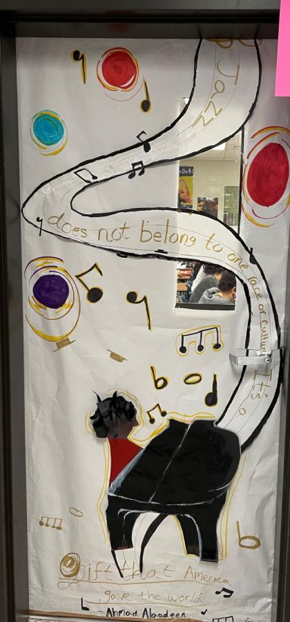 C103, Ward, shows a black pianist with a stream of music notes and part of a famous quote by saxophonist Ahmad Alaadeen. The quote reads, Jazz does not belong to any one race or culture, but is a gift America gave the world.