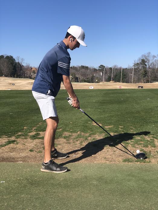 Josh Hemans, 10, practicing his swing on the Hamilton Mill Golf Course driving range.