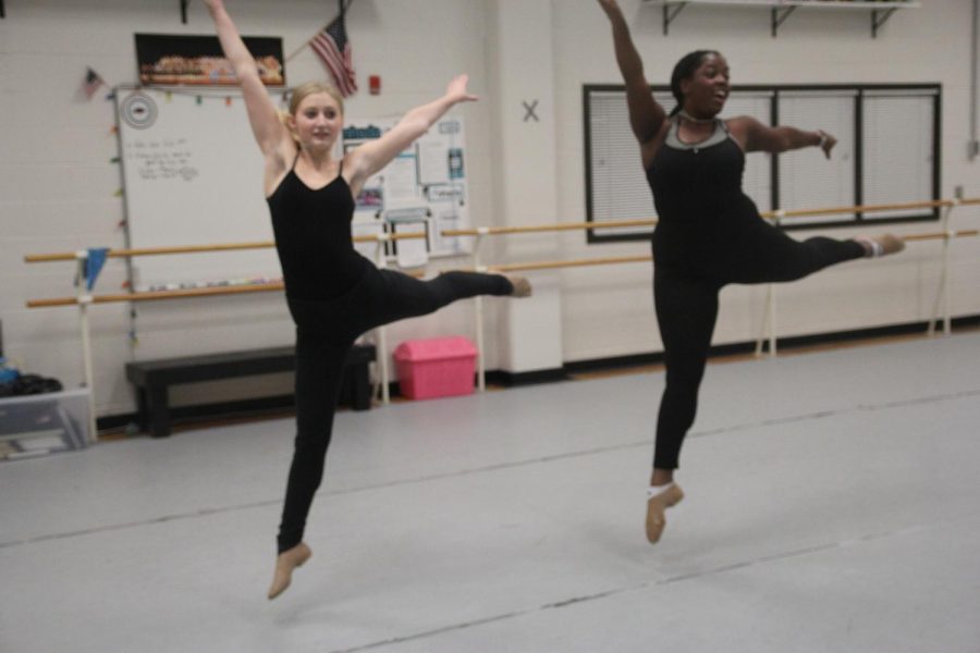 Cooper Constantino, 9, and Amirah Ashby, 10, practice their leaps in preparation for their upcoming performance.