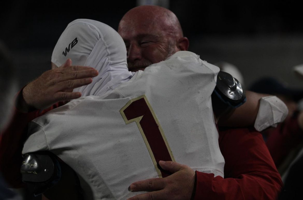 Coach Lovelady hugging a player during last years football State Championship.