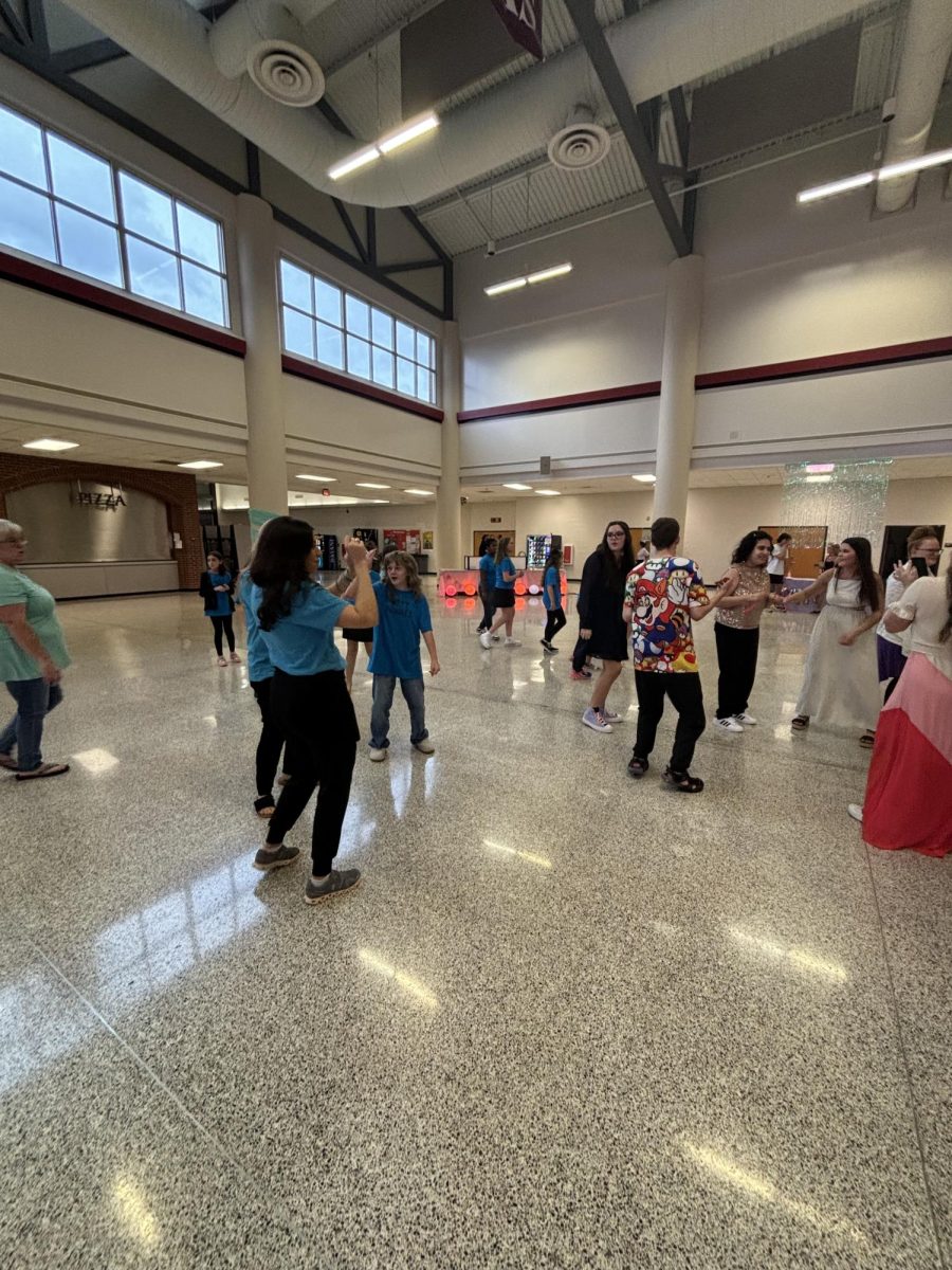 Students and teachers dancing and having fun at the dance. 