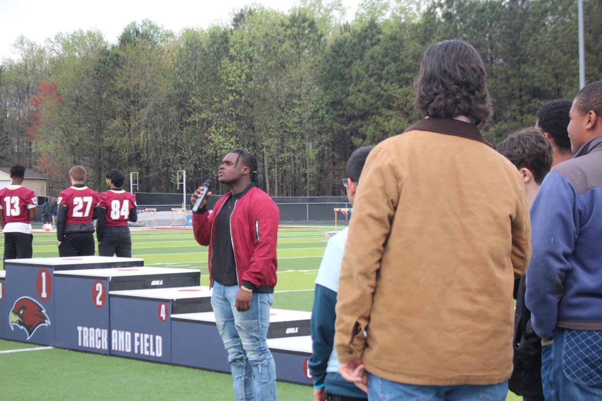Dunnington Walters, 12, a MIll Creek Football, Track and Chorus student, singing the National Anthem to the crowd.