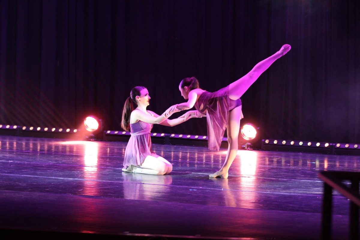 Lauren Barry, 12, and Meghan Baggs, 12, performing, "Hold On," by Extreme Music halfway through the first act of the dance show. 