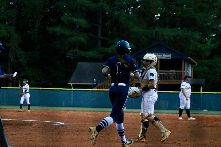 Ellie Kava running the bases at a softball game.